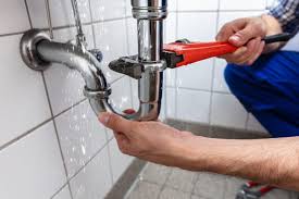 A person in blue attire is using a red pipe wrench to adjust or repair the metallic pipes under a sink. The pipes are leaking, and water droplets are visible, indicating an issue with the plumbing. The background consists of white tiles which appear clean and well-maintained. The person’s hands are visible; one is holding the pipe and the other is using the wrench. Plumbing Repairs When encountering a leaky pipe like the one in the image, it’s essential to address it promptly. Here are some steps you can take: Turn Off the Water Supply: Before attempting any repairs, turn off the water supply to prevent further leakage. Locate the shut-off valve for the affected area (usually under the sink) and close it. Assess the Damage: Inspect the pipe to determine the extent of the damage. Look for cracks, holes, or loose fittings. Repair Options: Depending on the severity of the leak, you can choose from the following repair options: Tighten Fittings: If the leak is minor, use a wrench to tighten any loose fittings. Patch Small Holes: For small holes, use epoxy putty or pipe repair tape to seal the leak. Replace Damaged Sections: If the pipe is severely damaged, consider replacing the affected section. Materials Needed: Pipe wrench (like the one in the image) Epoxy putty or pipe repair tape Replacement pipe (if necessary) Safety Precautions: Always wear gloves when handling plumbing materials. Be cautious of sharp edges on pipes. Remember that if you’re unsure about making the repairs yourself, it’s best to call a professional plumber. They can assess the situation and provide expert guidance to fix the issue effectively. 😊